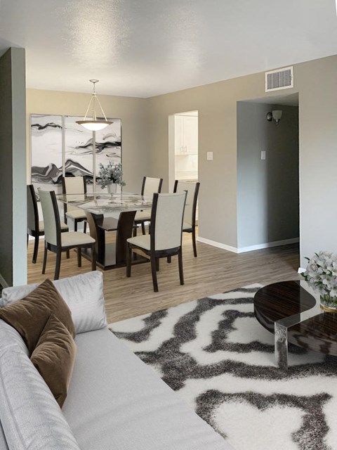 a living room with a couch and a dining room table